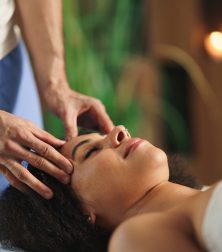 Person receiving a relaxing head massage in a spa setting, promoting wellness and peace.