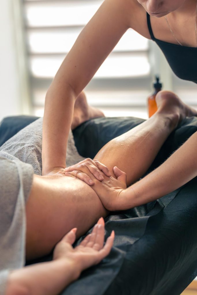 Person receiving relaxing leg massage therapy in a spa setting, promoting wellness and relaxation.