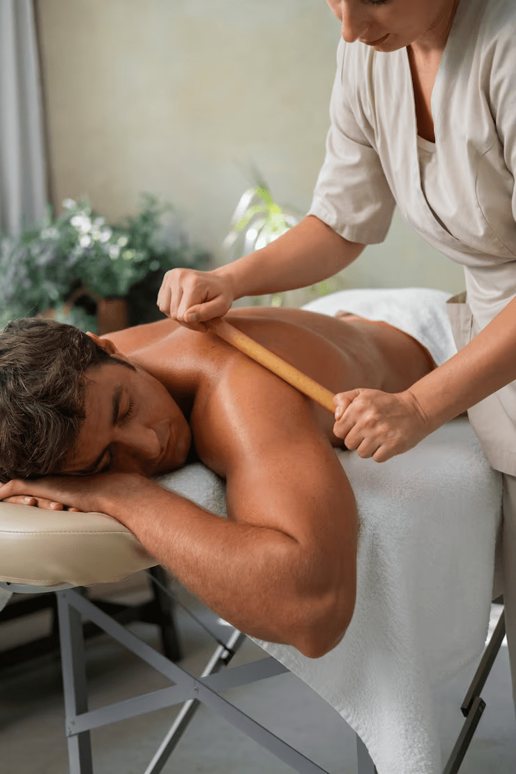 Person receiving a relaxing bamboo massage at a spa, enhancing wellness and tranquility