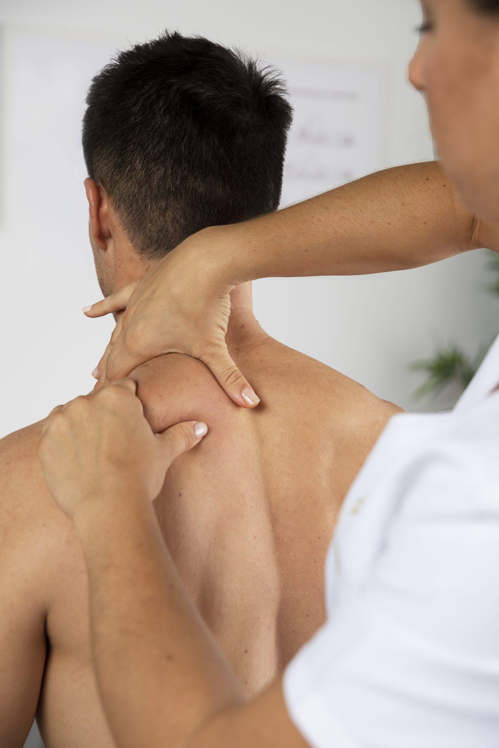 Person receiving a neck and shoulder massage for relaxation and pain relief in a wellness setting.