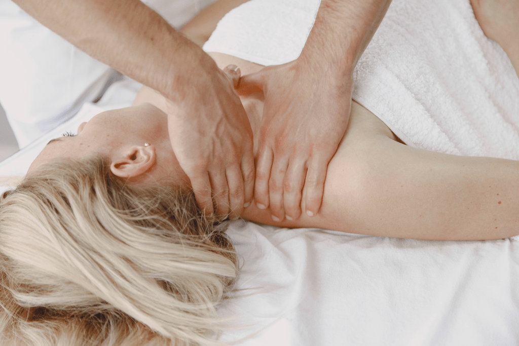 Person receiving a relaxing shoulder massage on a spa table, enhancing relaxation and wellness.