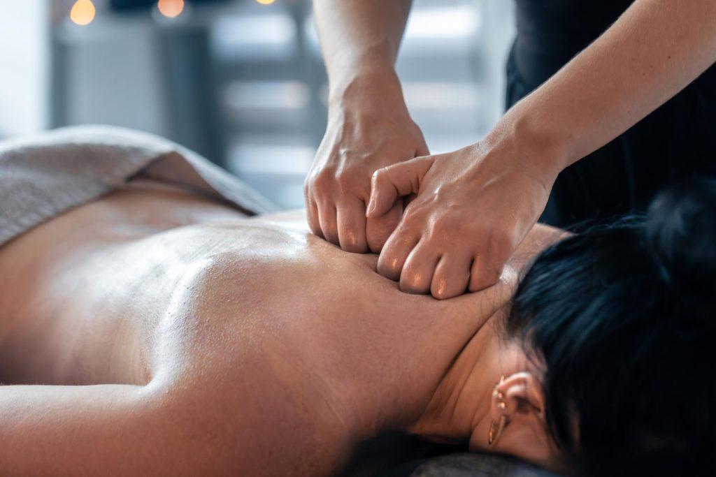 Person receiving deep tissue massage for relaxation and muscle relief in a spa setting