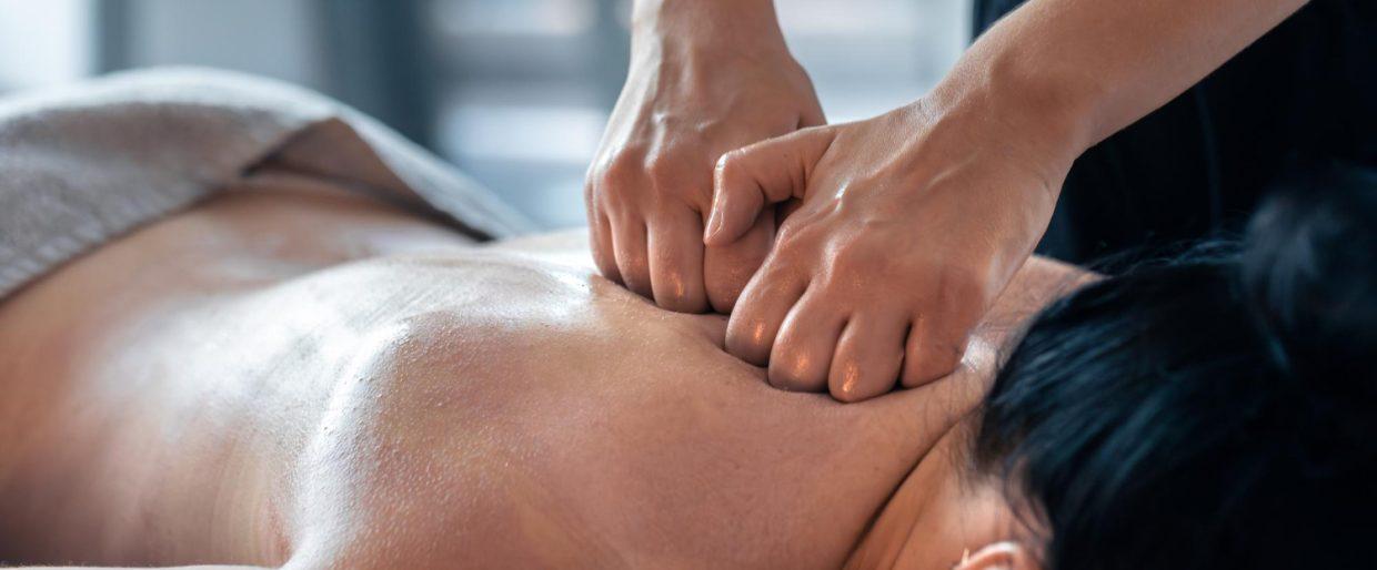 Person receiving deep tissue massage for relaxation and muscle relief in a spa setting