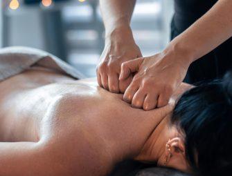 Person receiving deep tissue massage for relaxation and muscle relief in a spa setting